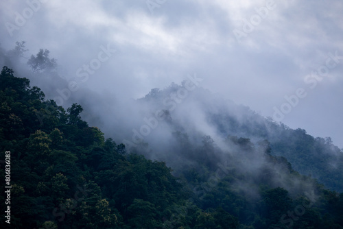 The background texture of mountains in the rainy season and the icy rain fog feels cool and refreshing with the green color of the forest that is cool and pleasing to the eye.