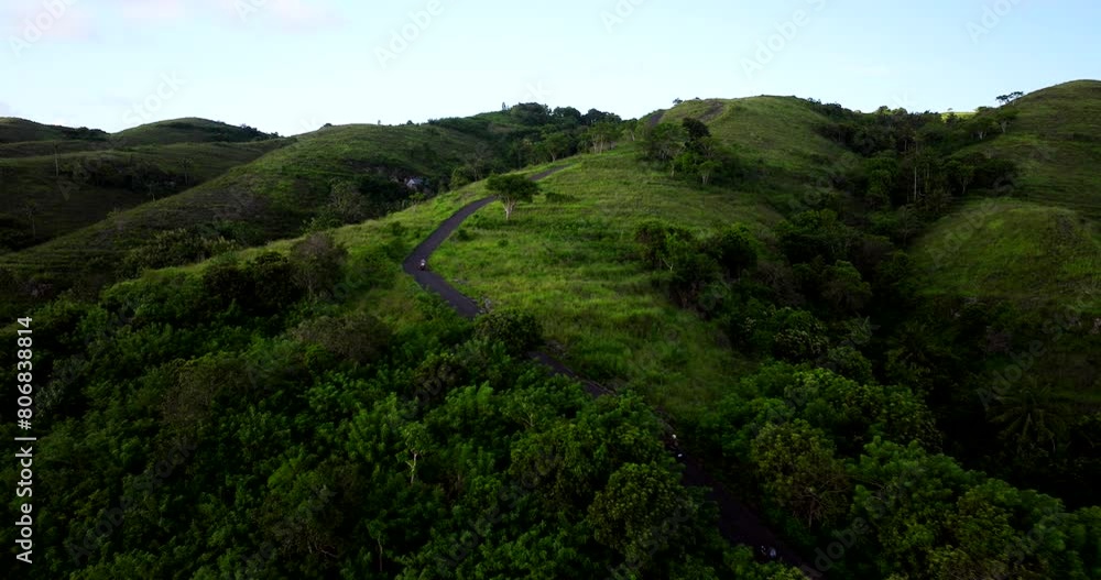 Sunset aerial view, female riding over green hills, famous places Bali Sunset aerial view, female riding over green hills, famous places Bali
