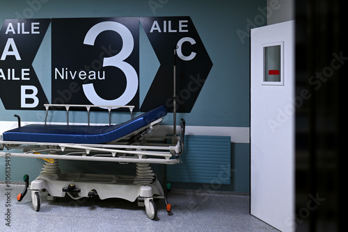 medical bed in the corridor of a hospital with wing information A B C level 3