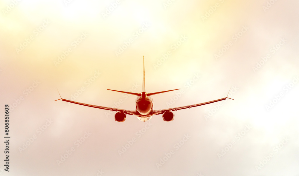Airplane in the sky at sunset or dawn Airplane in the sky at sunset or dawn