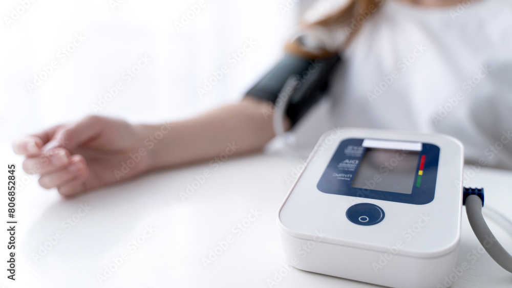 Woman measuring blood pressure with a tonometer Woman measuring blood pressure with a tonometer