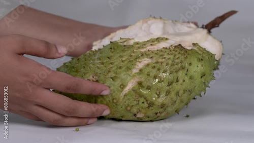 Tropical Delight: Slicing Spiky Soursop Fruit photo