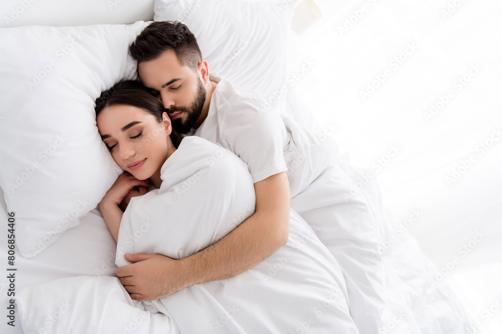 Photo of dreamy charming couple wear white t-shirts embracing sleeping indoors apartment bedroom Photo of dreamy charming couple wear white t-shirts embracing sleeping indoors apartment bedroom