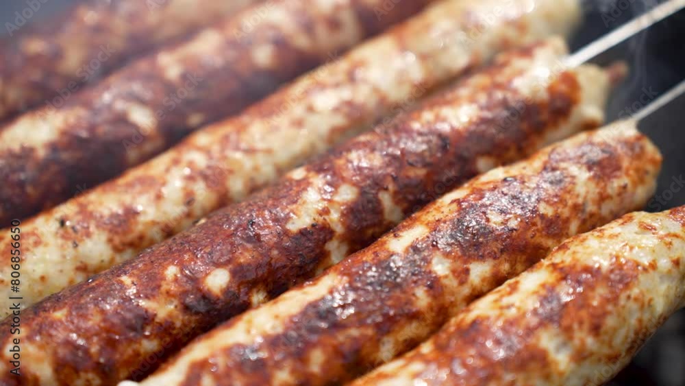 Grilled lula kebab on skewer on grill, close-up. Delicious homemade sausages Grilled lula kebab on skewer on grill, close-up. Delicious homemade sausages