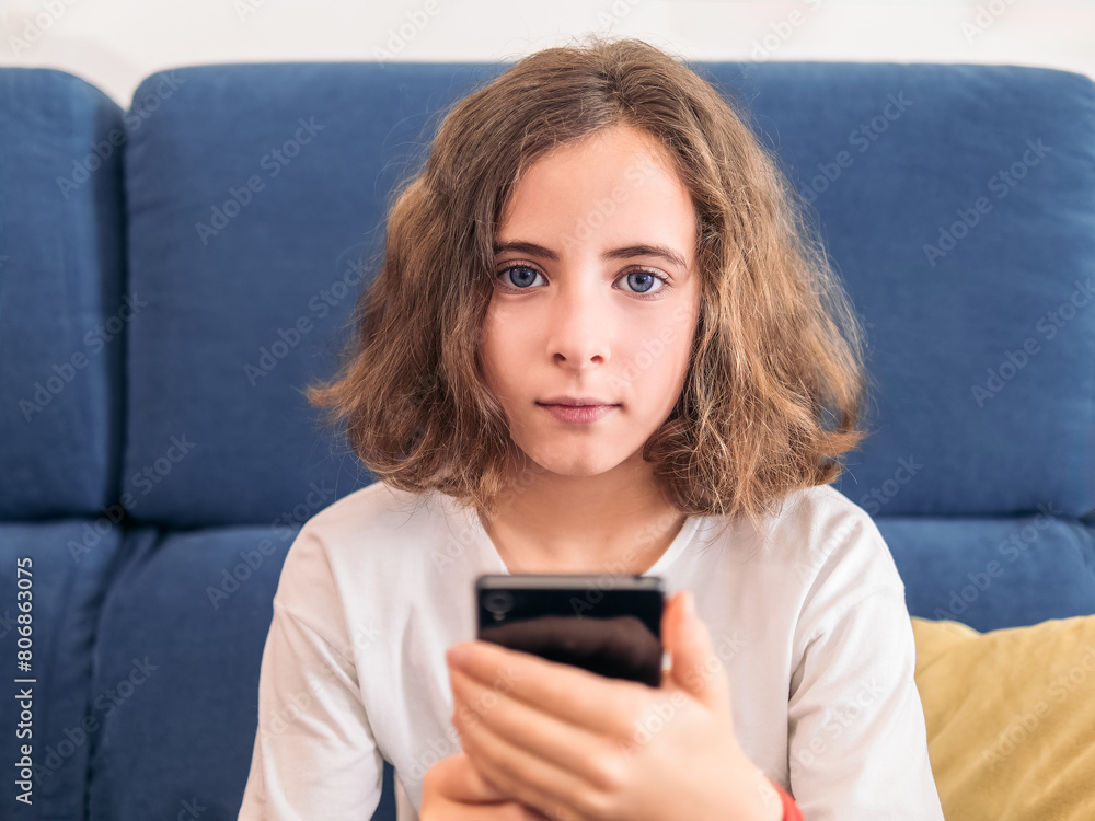 Young Girl Relaxing on Couch with Smartphone Young Girl Relaxing on Couch with Smartphone