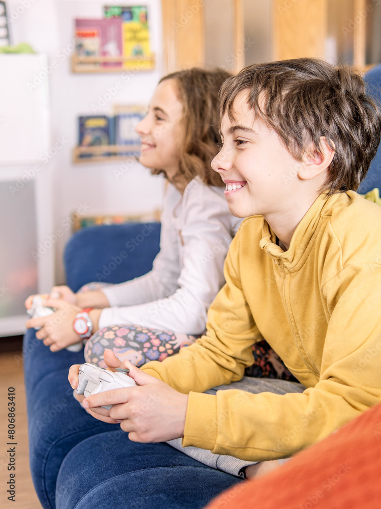 Children Playing Video Games on Blue Couch Children Playing Video Games on Blue Couch
