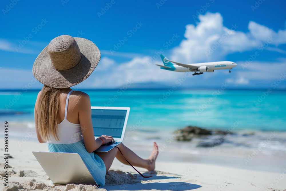 A female traveller booking plane tickets online using a laptop on a shady beach