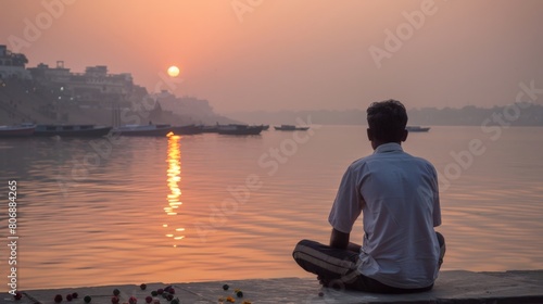 A man enjoying a peaceful moment by the Ganges river in Varanasi  India