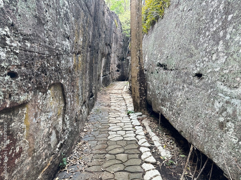 Photograph of a hiking trail through a rock tunnel. Photograph of a hiking trail through a rock tunnel.