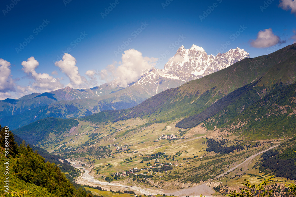 A spectacular view of the alpine valley of the Main Caucasus Range on a sunny day.