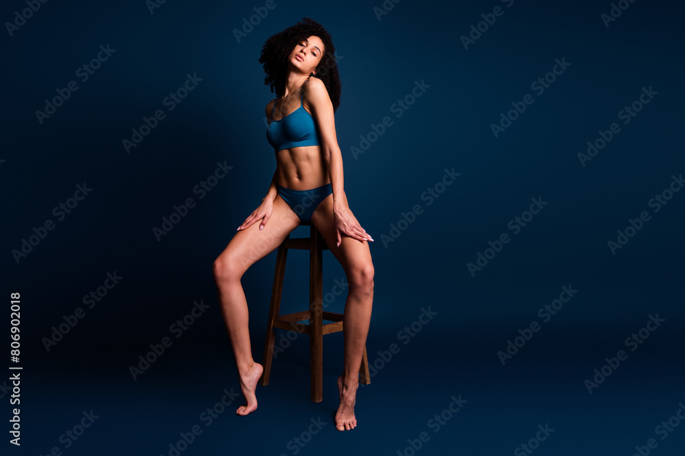 No filters photo of pretty confident girl in trendy lingerie sitting chair isolated on dark blue color background