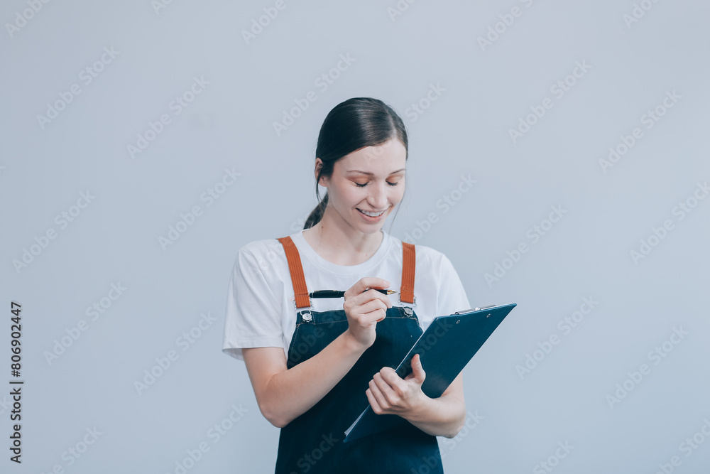 .Cheerful beautiful Asian woman wearing jeans overalls with excited doing winner gesture with arms raised isolated on white background.