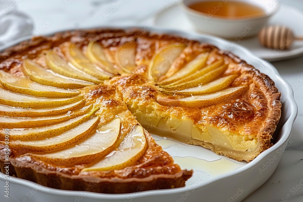 Delicious pear clafoutis in white baking dish with fresh pear slices, tempting dessert presentation Delicious pear clafoutis in white baking dish with fresh pear slices, tempting dessert presentation