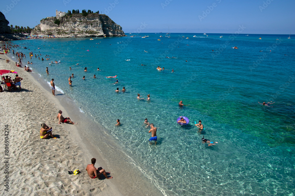Sea beach with turquoise water and sand where people relax