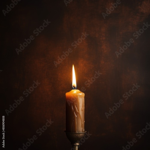 Brown background with white thin wax candle with a small lit flame for funeral grief death dead sad emotion with copy space texture for display products