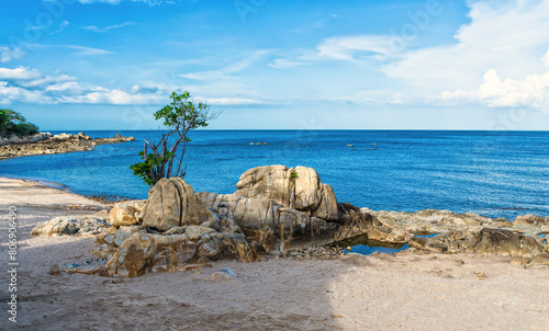 Scenic peaceful calm seascape of the Samui Island shore, with rocks and a sea horizon.