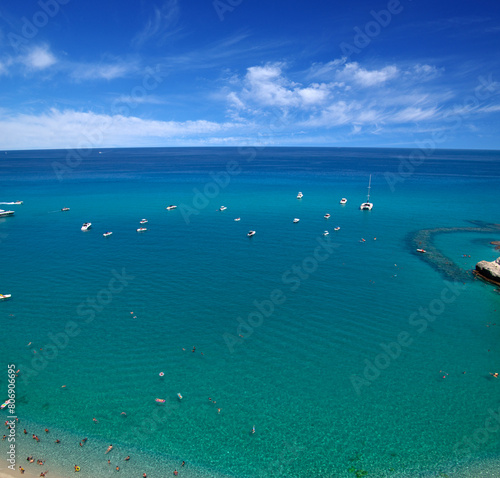 Sea beach with turquoise water and sand where people relax
