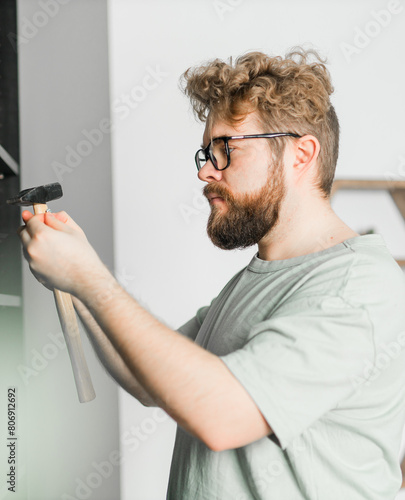 Portrait of man assembling furniture. Do it yourself furniture assembly at home