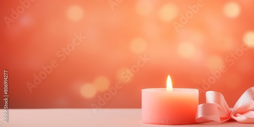 Coral background with white thin wax candle with a small lit flame for funeral grief death dead sad emotion with copy space texture for display
