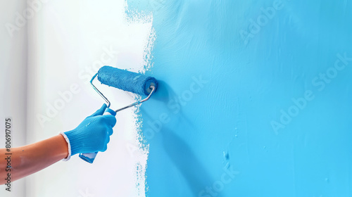 Wallpaper Mural Close-up of a gloved hand applying blue paint on a wall using a roller brush. Torontodigital.ca