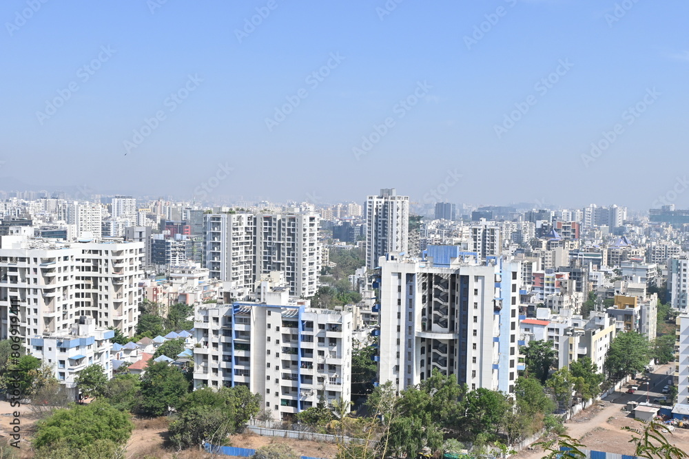 Fototapeta premium View of Pune in summer, Cityscape Skyline, buildings holdings, Signboards, and banners, Pune, Maharashtra, India