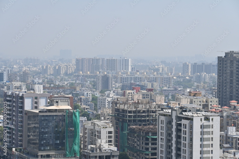 Fototapeta premium View of Pune in summer, Cityscape Skyline, buildings holdings, Signboards, and banners, Pune, Maharashtra, India