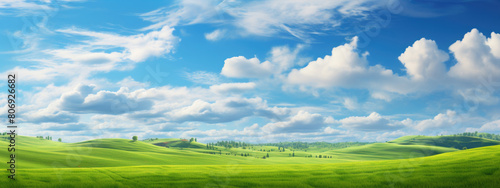 Natural background scene of green hills  blue sky  fluffy clouds  copy space