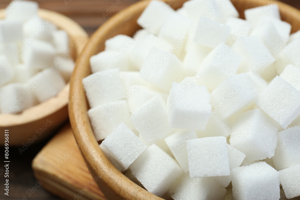 White sugar cubes on wooden table, closeup White sugar cubes on wooden table, closeup