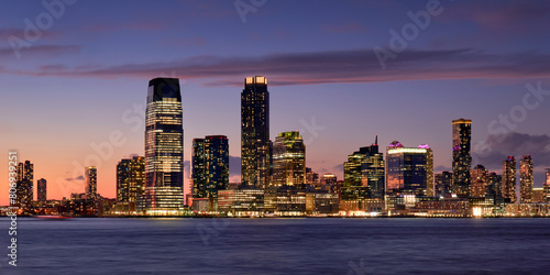 Panoramic view of Downtown Jersey City at twilight. Waterfront view of the Hudon River and Exchange Place skyscrapers, New Jersey
