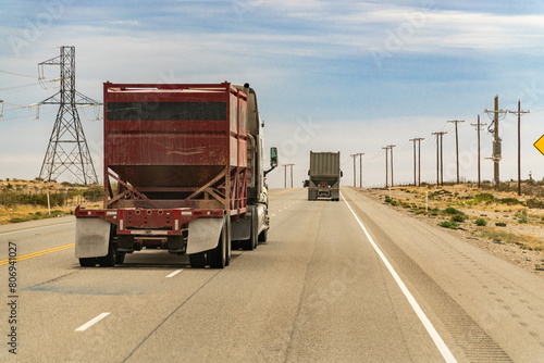 Midland, TX, US-March 31, 2024: Trucks driving through the Permian Basin fracking area.