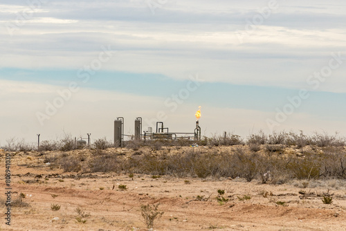 Canvas Print Midland, TX, US-March 31, 2024: Burning excess natural gas at a fracking pad on the Permian Basin