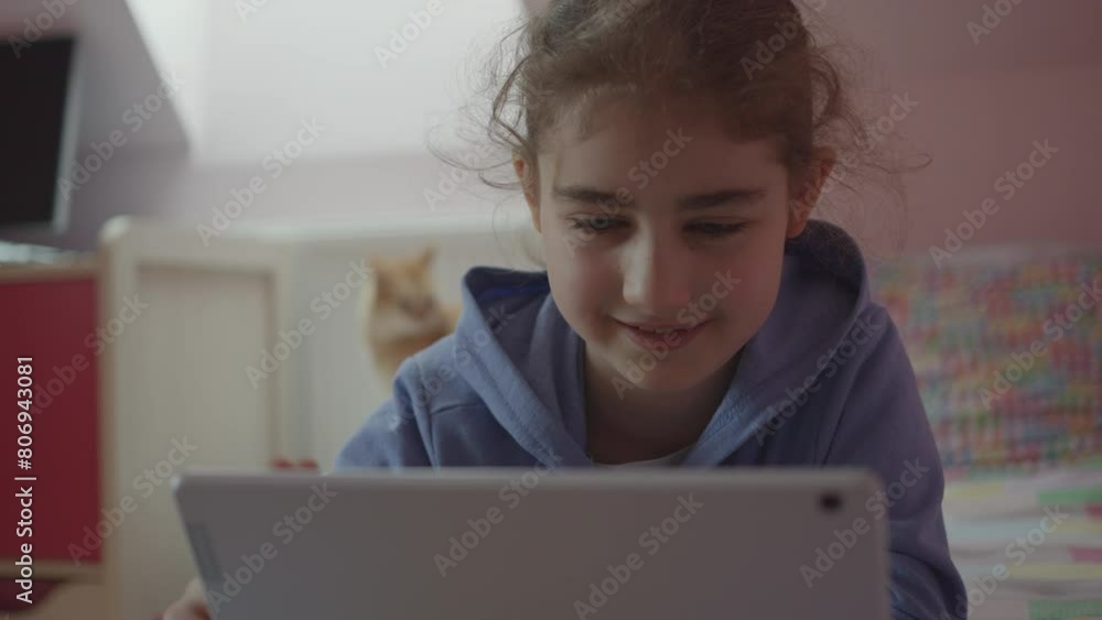 Child Using Digital Tablet Browsing Internet Chat At Home. Girl Watching Online Video Social Media on Digital Tablet in Bed in Bedroom. Dependence on Social Networks in Children. Not Healthy Lifestyle Child Using Digital Tablet Browsing Internet Chat At Home. Girl Watching Online Video Social Media on Digital Tablet in Bed in Bedroom. Dependence on Social Networks in Children. Not Healthy Lifestyle