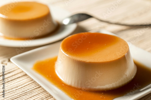 Fotografie Two egg and milk flats with liquid candy on white dishes