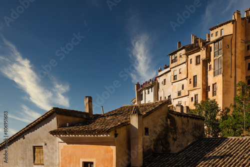 The architecture of the historic old town of Cuenca, Spain, with a blue sky in the background © Julian