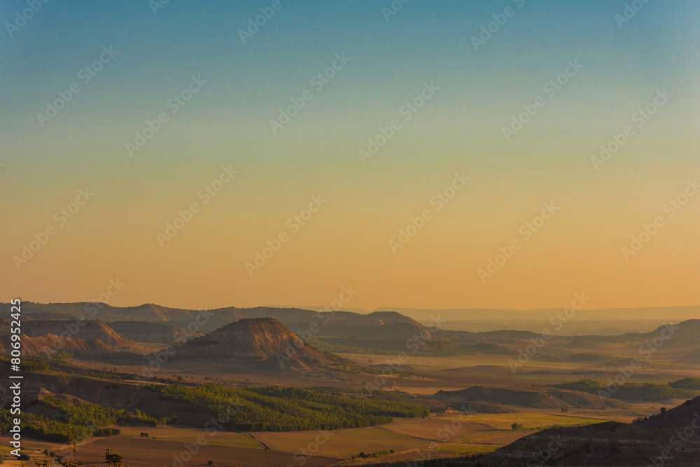 a valley surrounded by mountains with beautiful morning light, creating a serene and picturesque scene of nature awakening at dawn