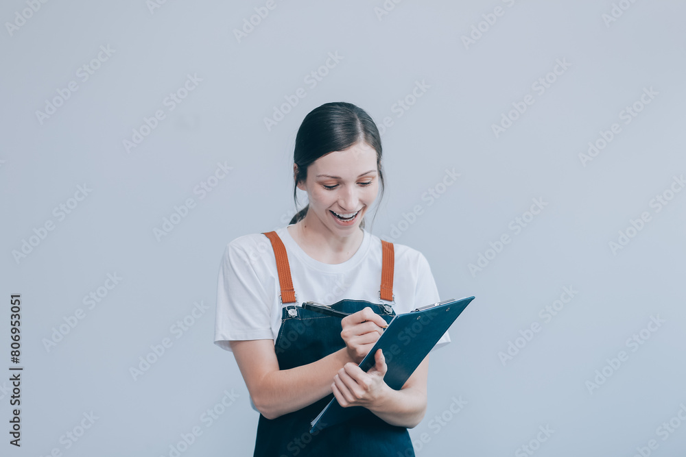 .Cheerful beautiful Asian woman wearing jeans overalls with excited doing winner gesture with arms raised isolated on white background. .Cheerful beautiful Asian woman wearing jeans overalls with excited doing winner gesture with arms raised isolated on white background.