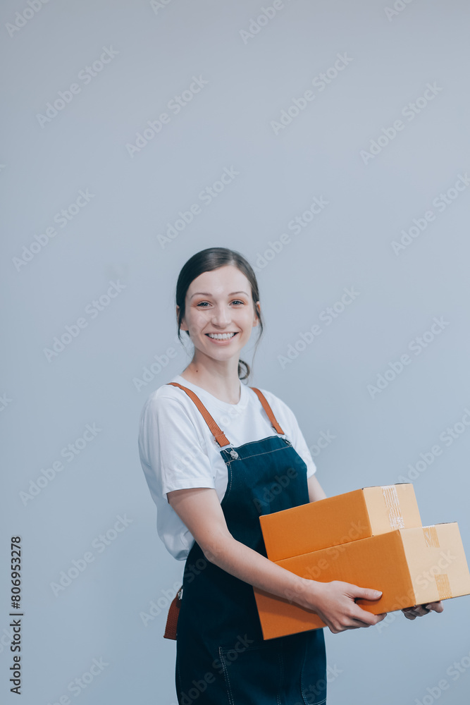 Smiling Asian woman in casual clothes holding a cardboard box mockup while standing against an isolated white background. shipping business concept Smiling Asian woman in casual clothes holding a cardboard box mockup while standing against an isolated white background. shipping business concept