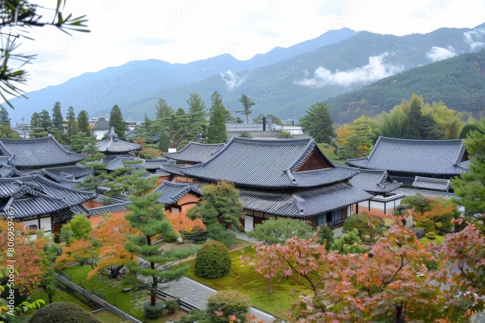 Fototapeta premium Traditional Korean architecture blends with vibrant fall foliage under a soft overcast sky.