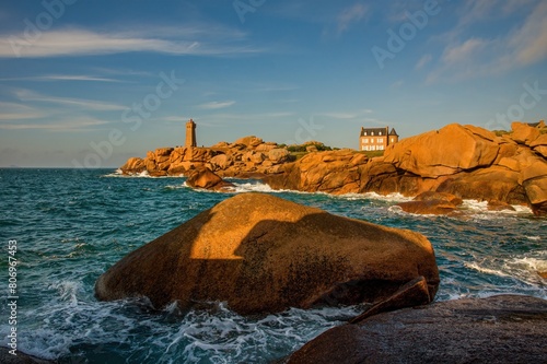 Atlantic ocean coast in Brittany near Ploumanach (France). Sea tide, waves, lighthouse in the background. Discover the beauty of the Brittany coast. photo