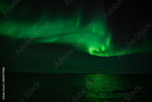 Green northern light, aurora borealis above sea