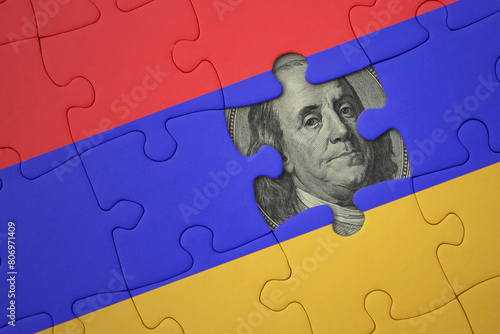puzzle with the national flag of armenia and usa dollar banknote. finance concept