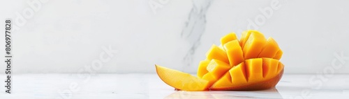 Photographic poster of a halfcut mango with pieces gently rising, surrounded by expansive negative space for a tranquil feel photo