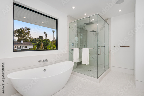 a bathroom with a glass shower and a tub in the middle