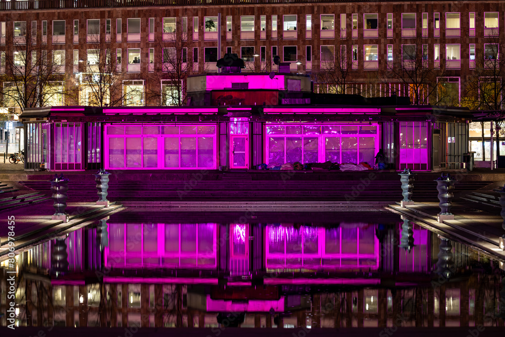 Fototapeta premium Stockholm, Sweden The reflection of a landmark building in the Kungstradgarden park at night during the springtime cherry blossom season in Forumdammen.