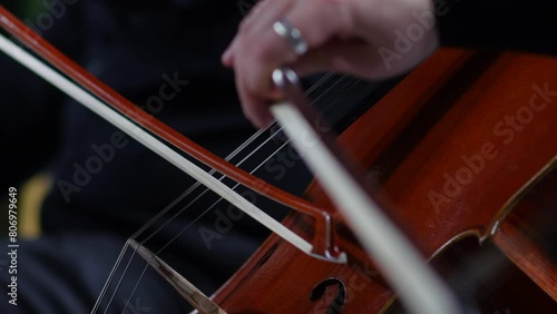 Symphony orchestra concert female musician playing cello, classical music playing stringed classical musical instruments, Closeup view of violoncello and hands of musician, cellist is playing cello