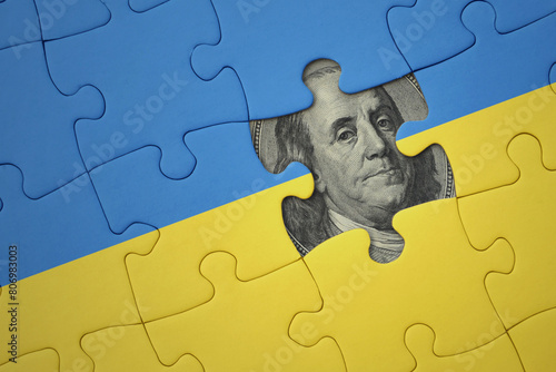 puzzle with the national flag of ukraine and usa dollar banknote. finance concept
