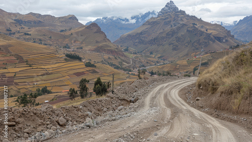 A dirt road winds through a mountainous area