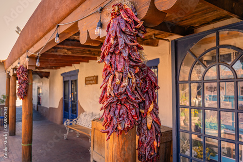 Close-up view of arrangements of dried chili peppers, called ristras, hanging  from wooden ceiling in Albuquerque New Mexico. photo