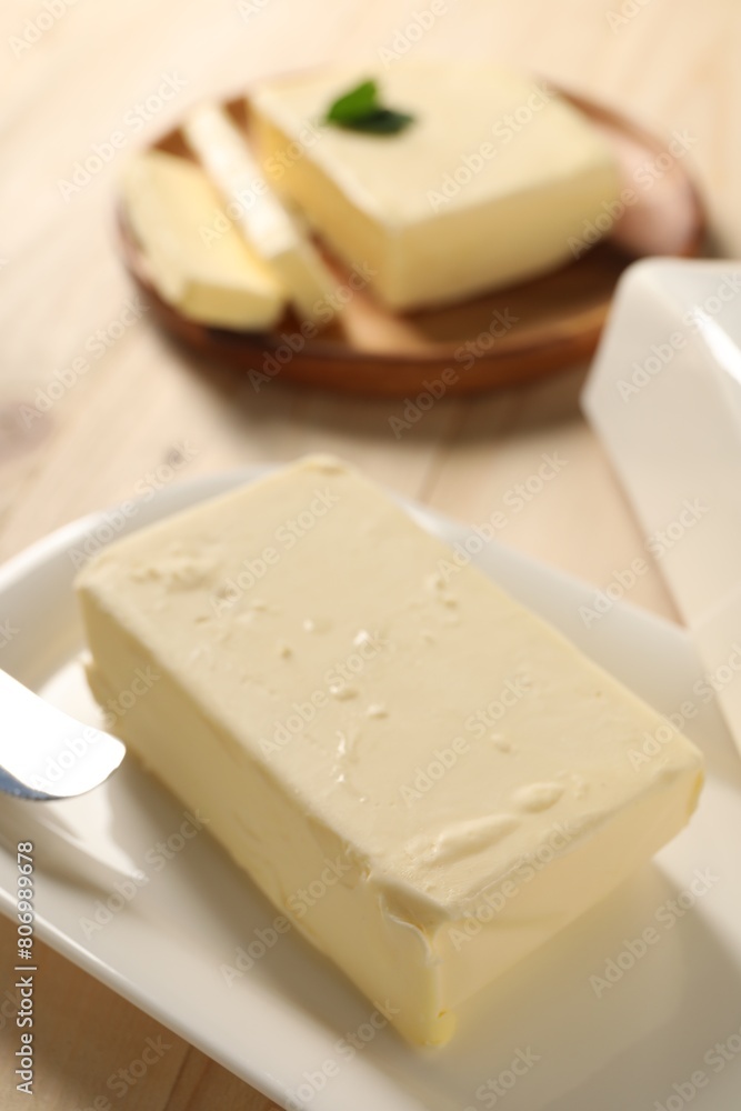 Block of tasty butter on wooden table, closeup Block of tasty butter on wooden table, closeup