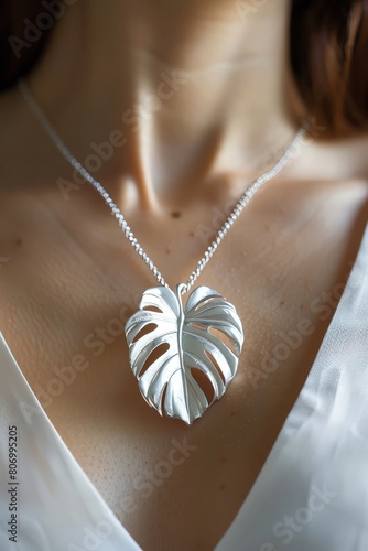 A contemporary jewelry design inspired by the elegant shape of monstera leaves, crafted in silver photo